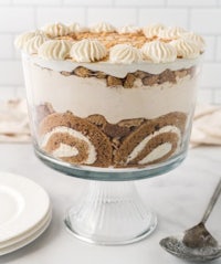 a trifle in a glass dish with whipped cream on top