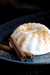 a blue plate with cinnamon and whipped cream on it