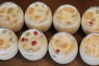 a group of glasses filled with fruit and ice cream