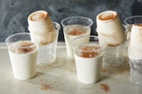 a group of plastic cups with cinnamon in them