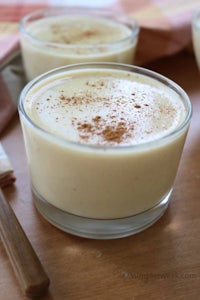 three bowls of pudding with cinnamon on a wooden table