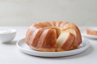 a bundt cake on a plate with a slice taken out