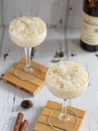 two glasses with ice cream and a bottle of whiskey